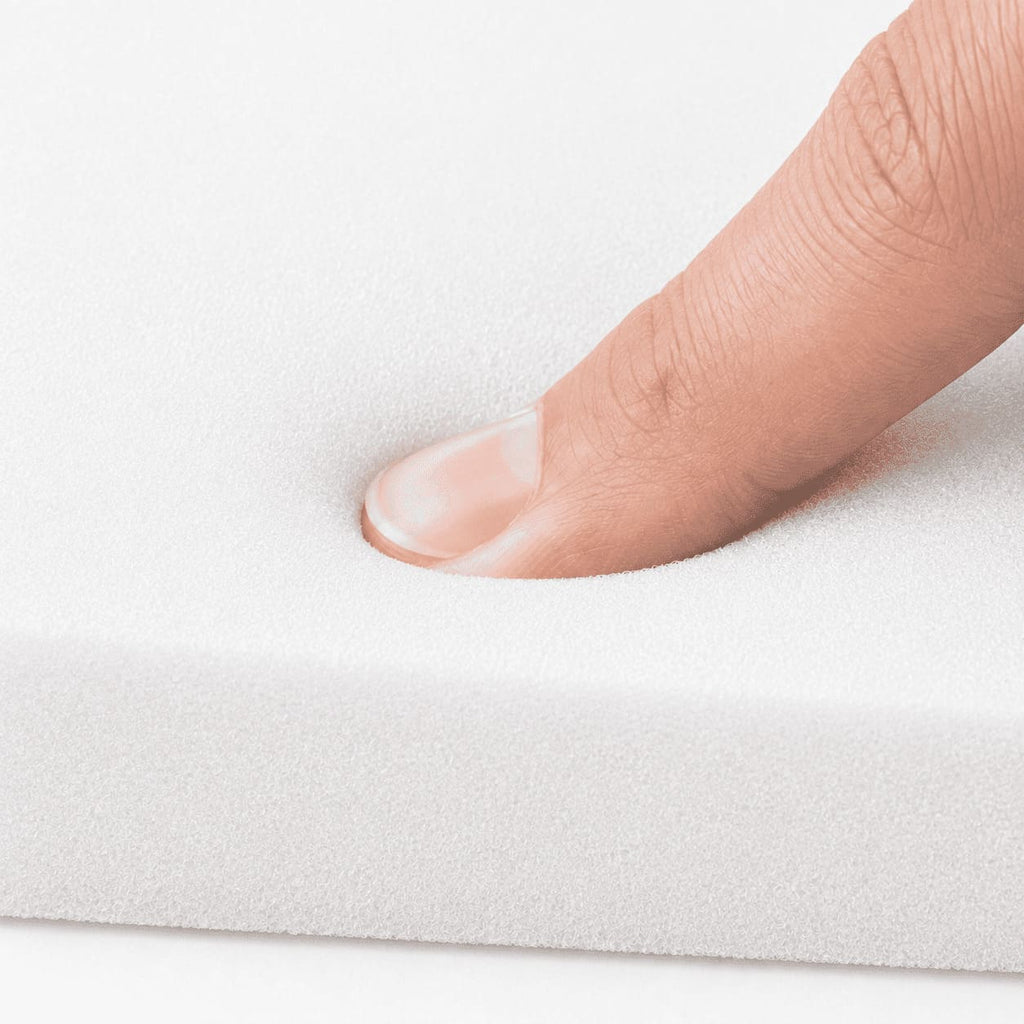 Close-up of soft white lipo foam pad texture showing its cushioned surface for post-surgery compression support